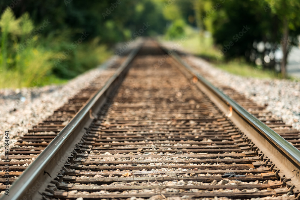 Train railroad tracks with a very shallow depth of field mid day