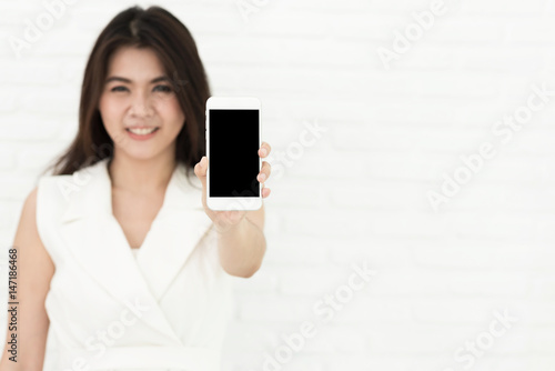 Asian woman present blank screen smartphone