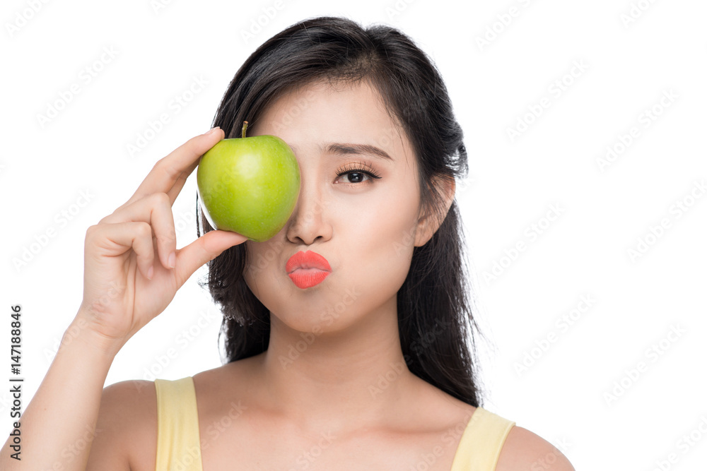 Pretty young asian woman holding fresh apple isolated on white background. Pretty young asian woman holding fresh apple isolated on white background.