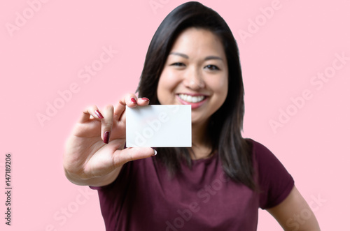 Smiling Chinese woman holding a business card