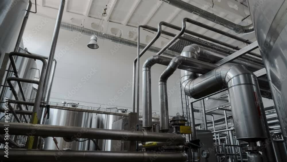 Wide zoom-in shot of industrial interior. Robotic factory line for processing and quality control of pure spring water bottled into canisters. Wide zoom-in shot of industrial interior. Robotic factory line for processing and quality control of pure spring water bottled into canisters.