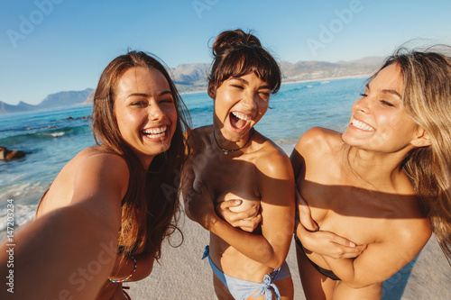 Beautiful women taking selfie by the sea