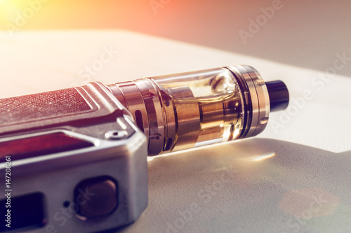 Photos Vape mod on dna chip and tank with vaping liquid