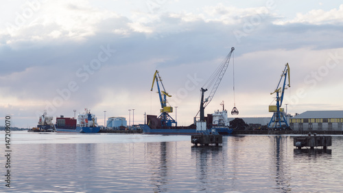 cranes at harbor against sky © Berlin85