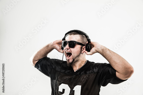 creative rapper in the headphones and dark glasses performs a ra