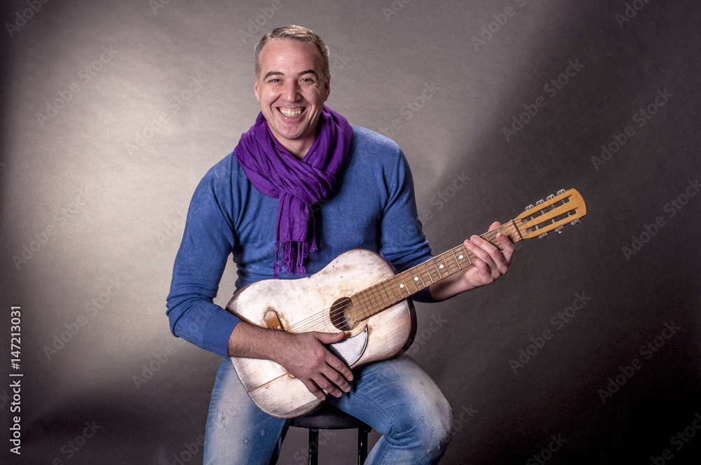 Obraz premium Portrait of elegant man with a guitar