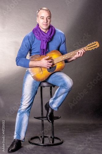 Portrait of elegant man with a guitar