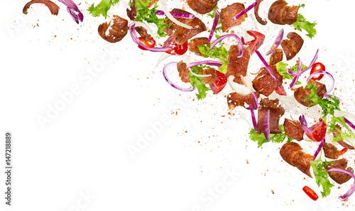 Kebab ingredients flying, close-up.