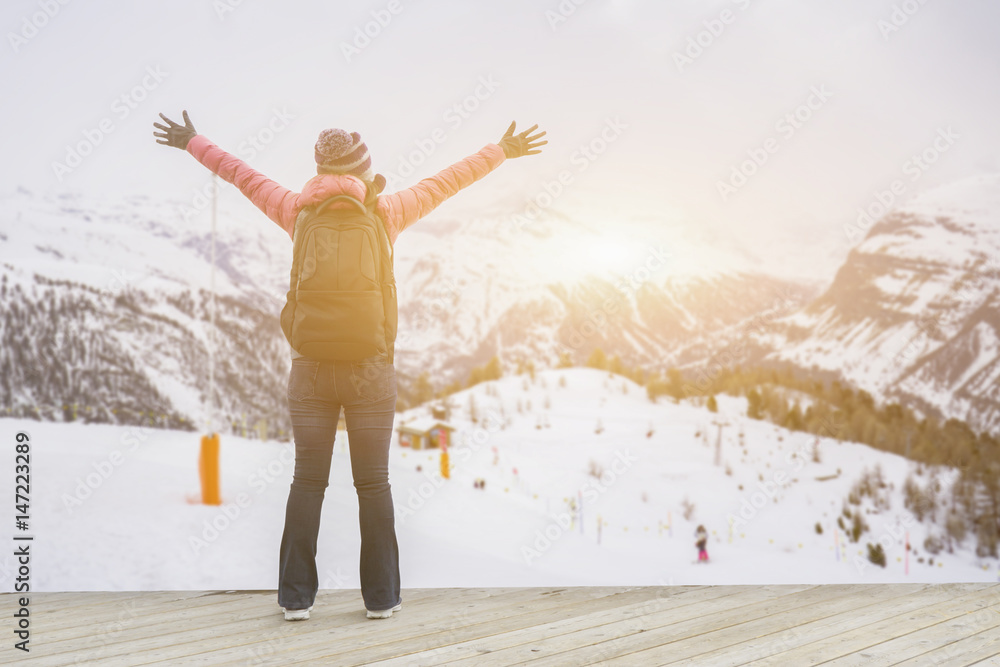 Happy young girl traveler woman raising hands standing in View of the Eiger, Monch and Jungfrau peaks from the Schilthorn,Bernese Alps, Switzerland,Europe,selective focus,vintage color Happy young girl traveler woman raising hands standing in View of the Eiger, Monch and Jungfrau peaks from the Schilthorn,Bernese Alps, Switzerland,Europe,selective focus,vintage color