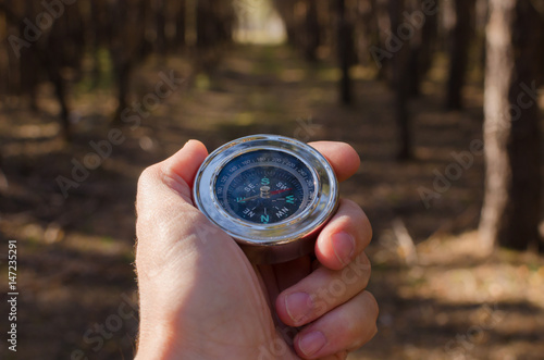Male hand holding a compass