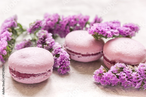 spring woman breakfast with macaroons and mauve flowers white background