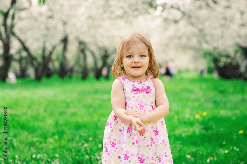 cute little happy toddler girl portrait walking in spring or summer park or garden cute little happy toddler girl portrait walking in spring or summer park or garden