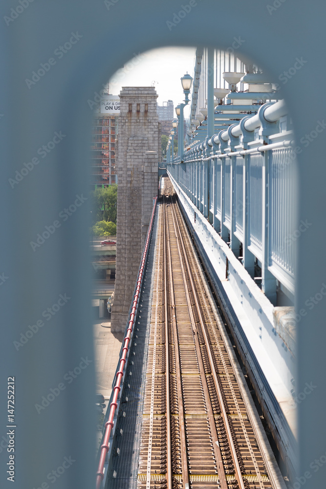 Fototapeta premium Looking thru the Arched Hole at the Train Tracks on Bridge