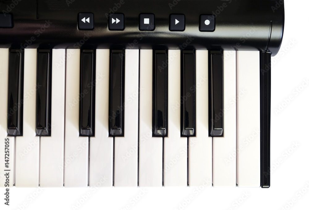 Naklejka premium Piano keyboard with white and black keys isolated on blue jeans background front view vertical photo close up