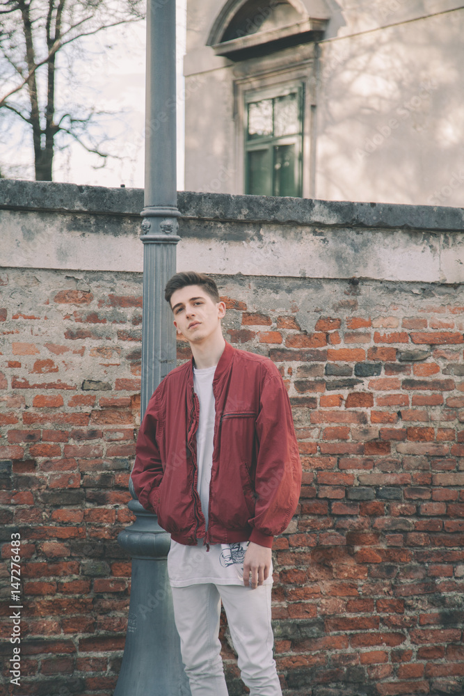 Young model posing in the street. Outdoor portrait of a cool guy Young model posing in the street. Outdoor portrait of a cool guy