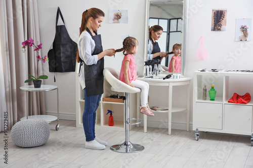 Cute little girl in hairdre...