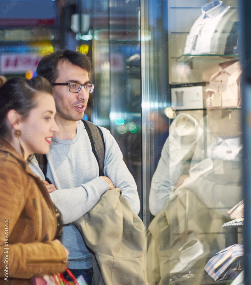 Woman and man in front of clothing store Woman and man in front of clothing store