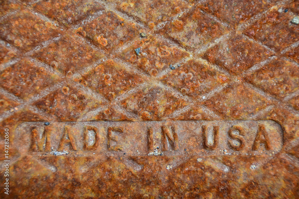 Rusted  Made in USA cast iron cover on sewer drain
