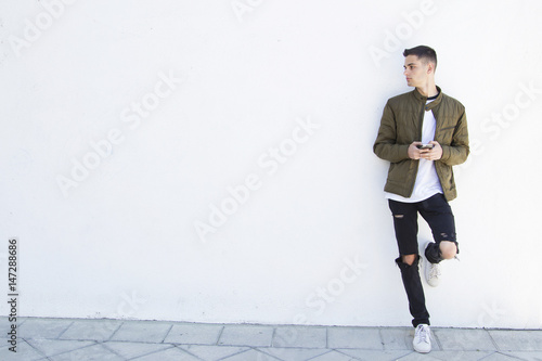 young man with mobile phone on street
