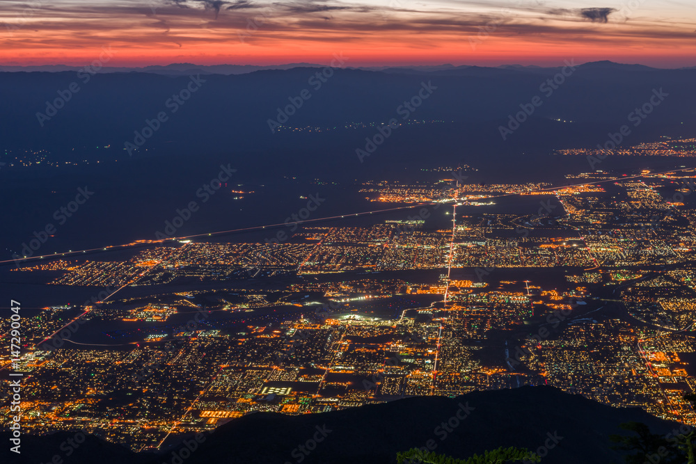 Sunrise over Palm Springs, California with web of street lights -3