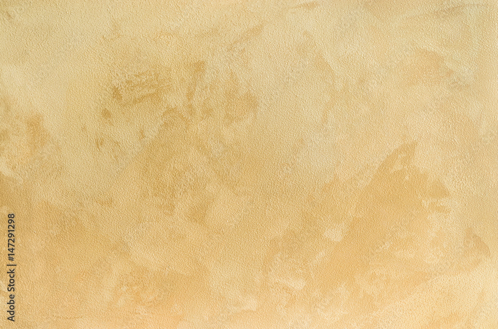Fototapeta premium Textured background. Decorative plaster walls, external decoration of facade. Texture of beige.