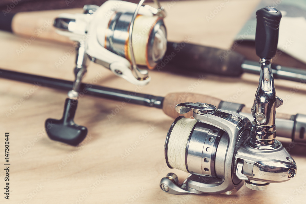 Fishing rods and reels with line. Close up and selective focus Fishing rods and reels with line. Close up and selective focus