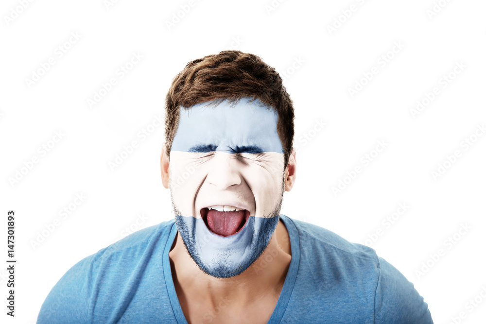 Screaming man with Argentina flag on face. Screaming man with Argentina flag on face.