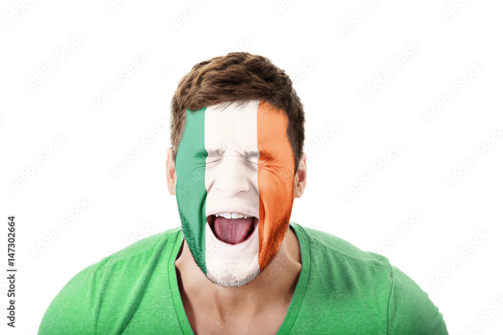 Screaming man with Ireland flag on face. Screaming man with Ireland flag on face.