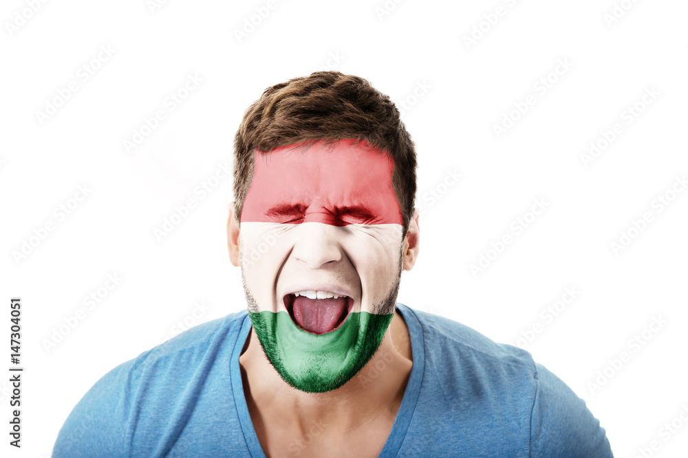 Screaming man with Hungary flag on face. Screaming man with Hungary flag on face.