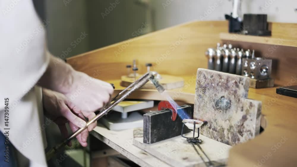 Close up of woman worker s hands with a blowtorch in a factory. Concept of manual labor. Locked down slow motion close up shot Close up of woman worker s hands with a blowtorch in a factory. Concept of manual labor. Locked down slow motion close up shot