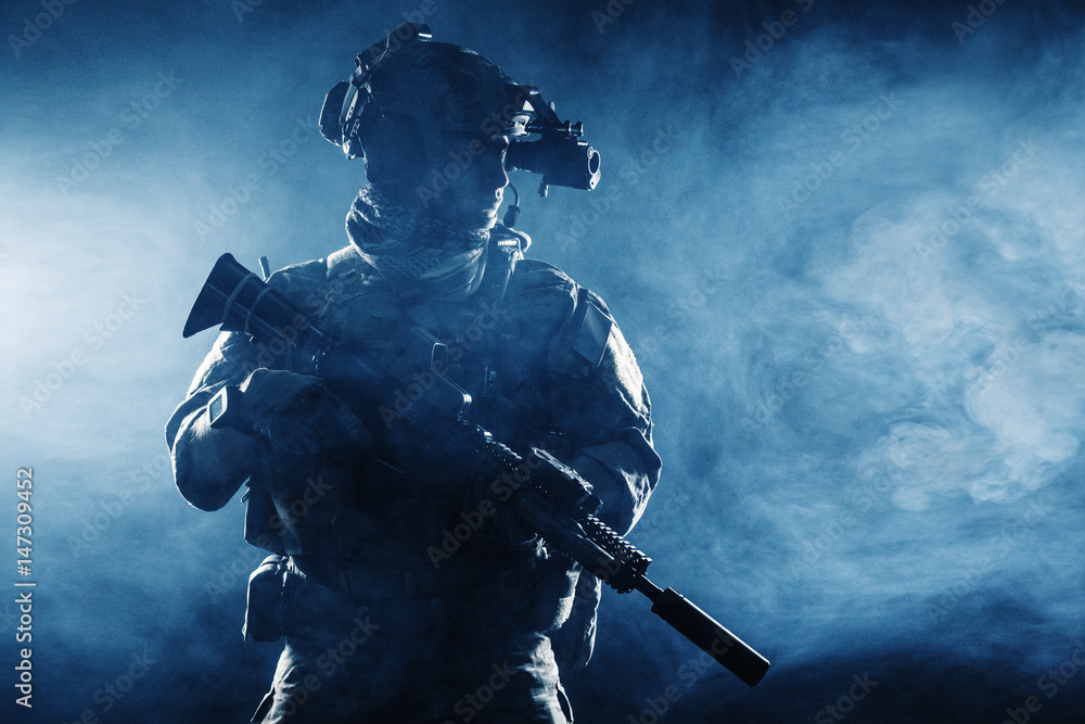 Army soldier in Combat Uniforms with assault rifle, plate carrier and combat helmet are on, Shemagh Kufiya scarf on his neck. Studio contour silhouette shot, backlight, dark glowing smoke background Army soldier in Combat Uniforms with assault rifle, plate carrier and combat helmet are on, Shemagh Kufiya scarf on his neck. Studio contour silhouette shot, backlight, dark glowing smoke background