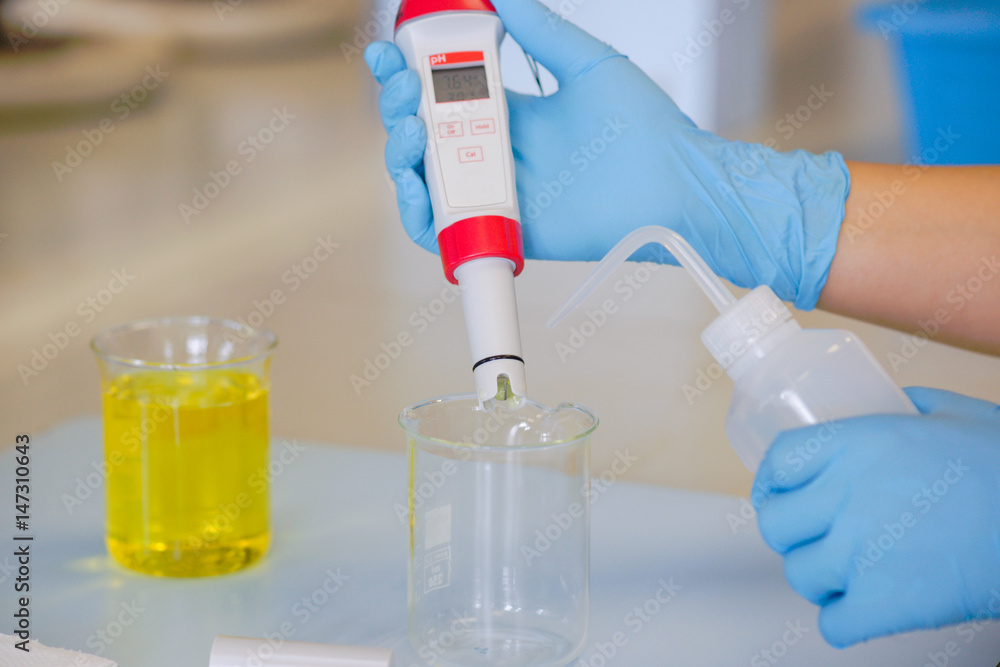 The scientist work at the chemical solution with handle pH meter The scientist work at the chemical solution with handle pH meter
