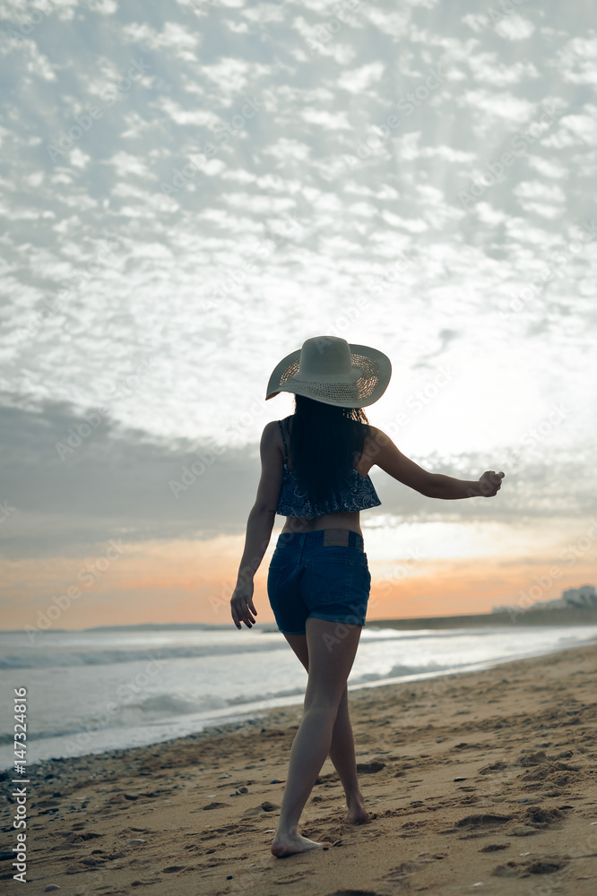 Beach silhouette of the woman dancing during beautiful sun dawn. Natural light and darkness background