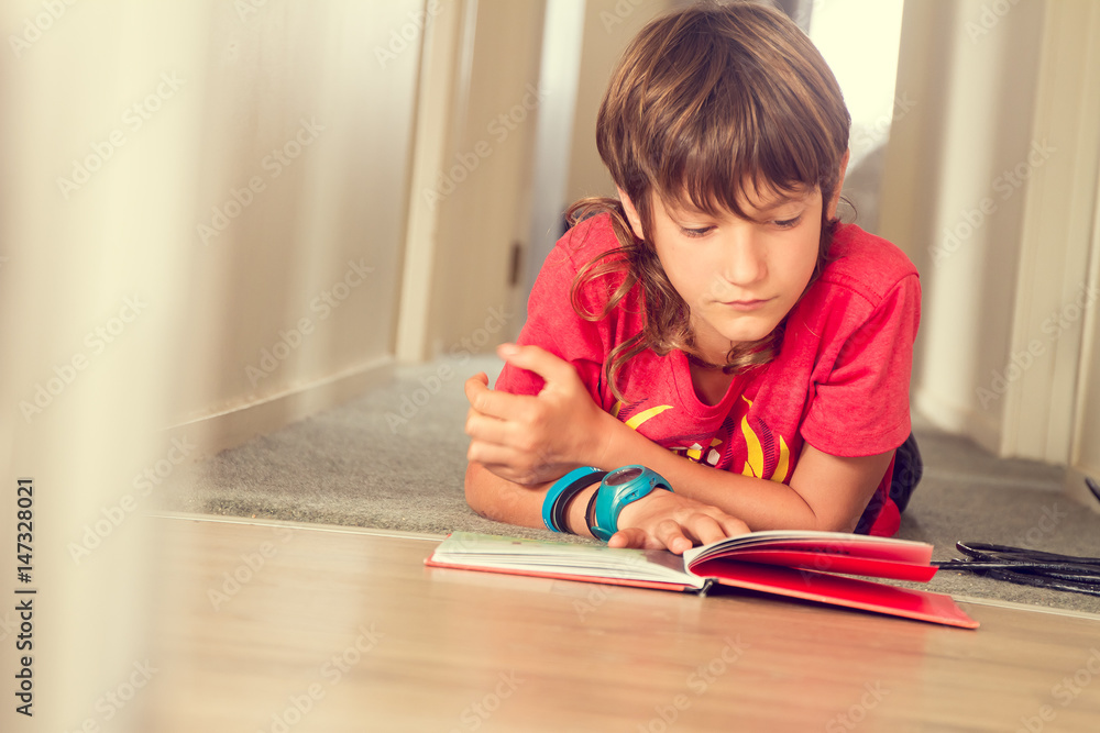 indoor portrait of young boy reading a book at home indoor portrait of young boy reading a book at home