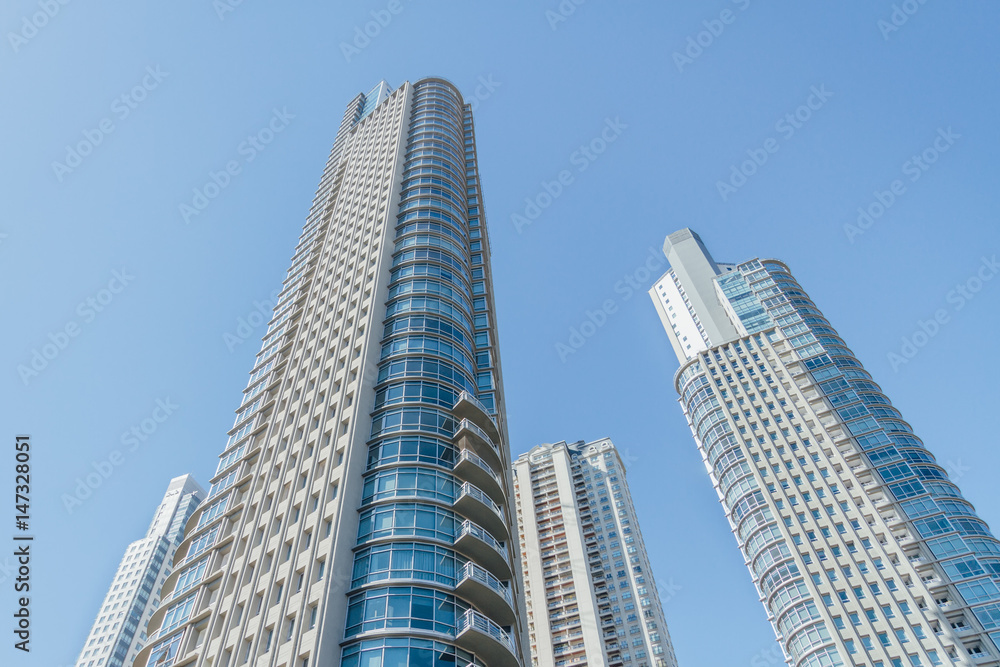 Apartment towers seen from below with blue sky