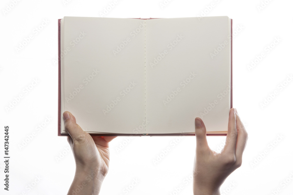 Obraz premium woman hand hold a red book isolated white.