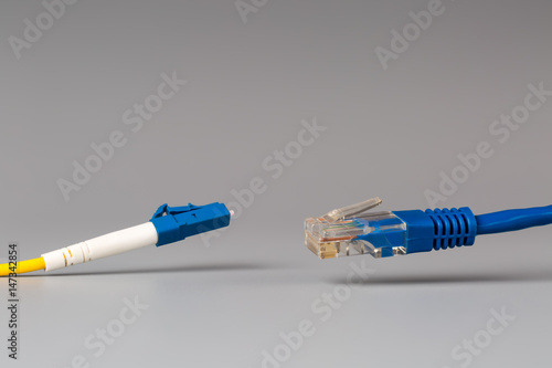 Close-up of optical patch cord lc and copper cable with plug rj45 photo