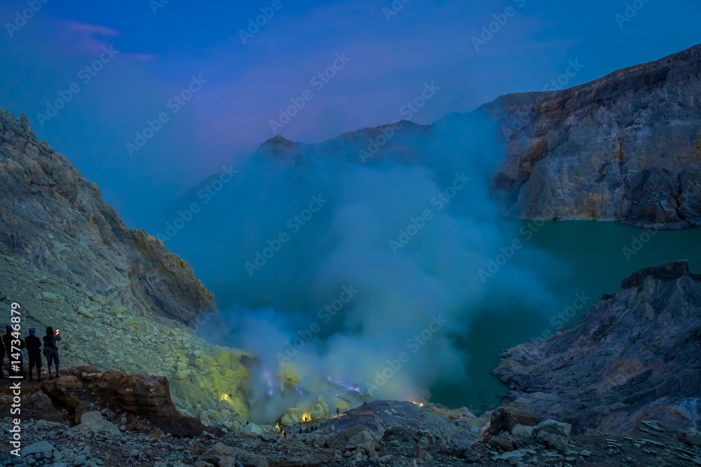 KAWEH IJEN, INDONESIA: Nice overview of sulfur mine with miners working next to volcanic crater lake, spectacular nature