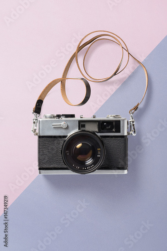 retro hipster poster or card with vintage camera on a dichromatic pastel colored paper background, copyspace for a motivational quote or any other photography related text