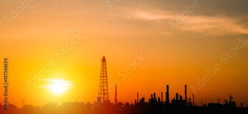 Oil refinery factory and logistic over sunrise Bangkok Thailand, with silhouette, Industrial zone, The equipment of oil refining, industrial pipelines of an oil-refinery plant, copy space.