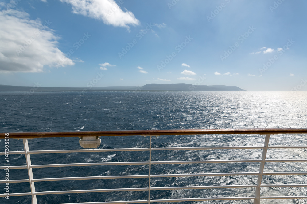 Ocean with sunny sky seeing from cruise ship upper deck, vacation travel by boat