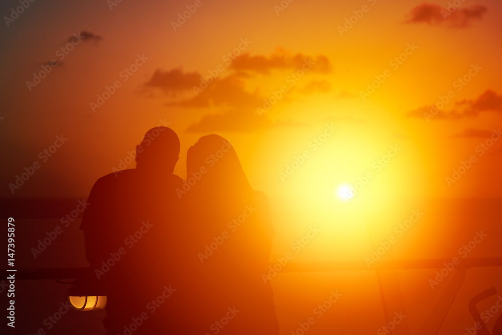 Couple watching sunset from cruise ship