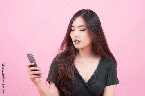portrait of young sexy asian woman isolated on pink background