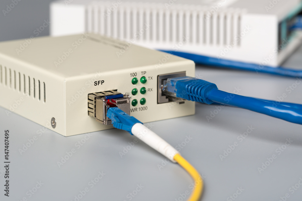 1Gbps optical media converter with SFP module connected to ethernet port SOHO router - obrazy, fototapety, plakaty 