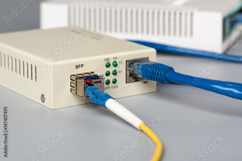 1Gbps optical media converter with SFP module connected to ethernet port SOHO router photo