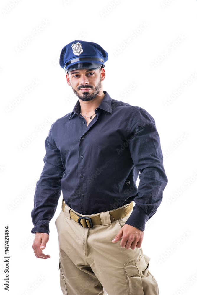 Handsome muscular male posing confidently in police cap and uniform on white background. Handsome muscular male posing confidently in police cap and uniform on white background.