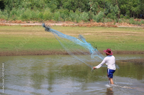 Men throw a net on the river