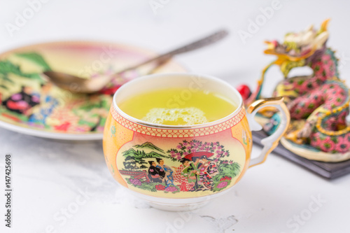 A cup of green tea on a white background. Hot drink