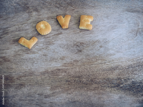 Letter biscuit word of 'Love' on wooden background