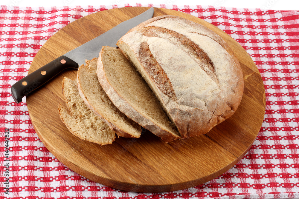 freshly baked bread with knife on wood background freshly baked bread with knife on wood background